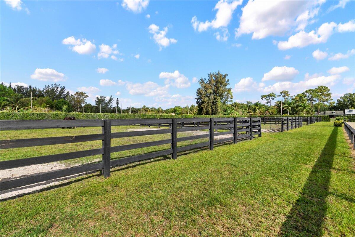 16575 Van Gogh Boulevard, Unit HORSE STALLS) Loxahatchee, FL 33470 - Photo 29 of 50 a view of a golf course with a lake
