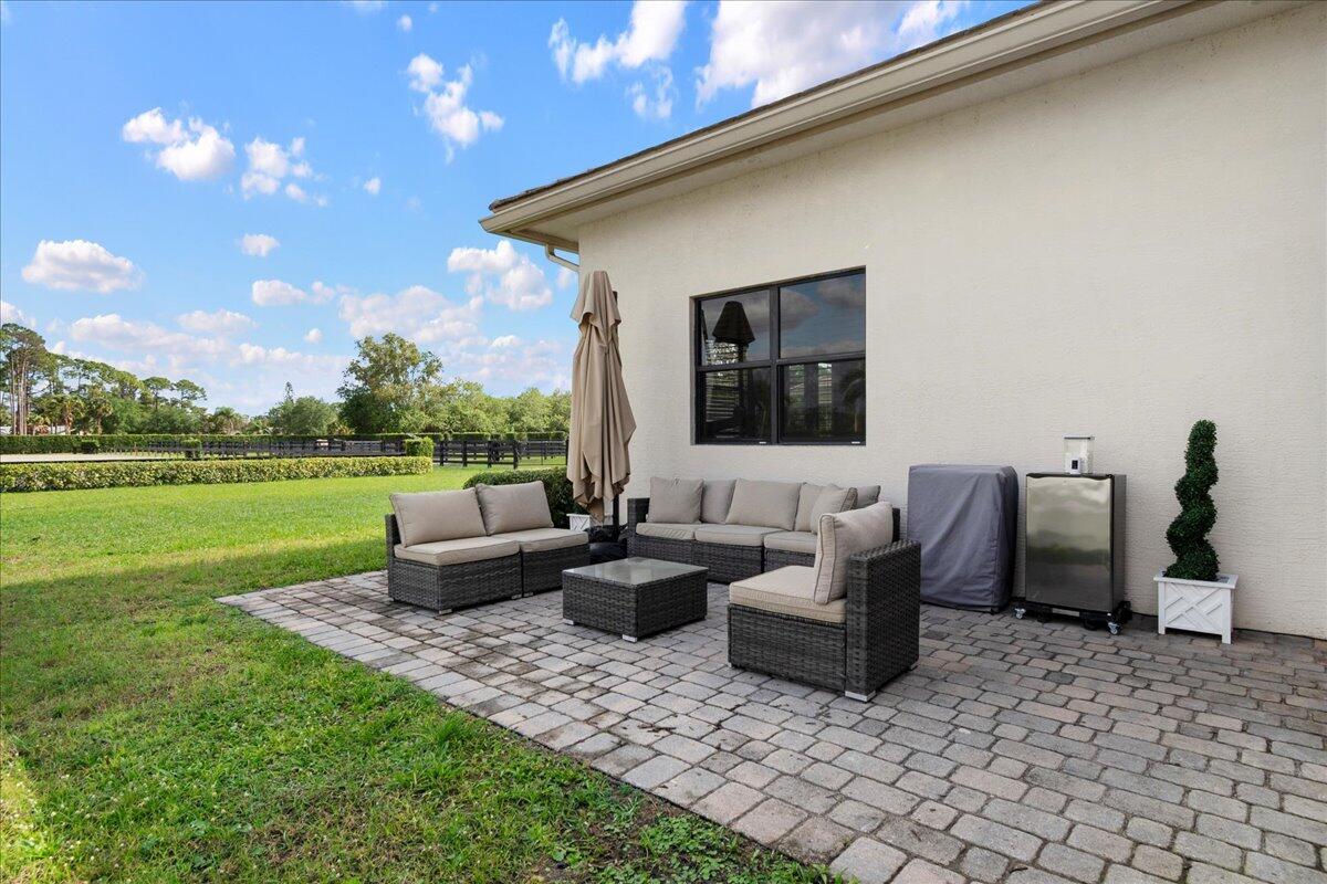 16575 Van Gogh Boulevard, Unit HORSE STALLS) Loxahatchee, FL 33470 - Photo 31 of 50 a view of a patio with chairs and a patio