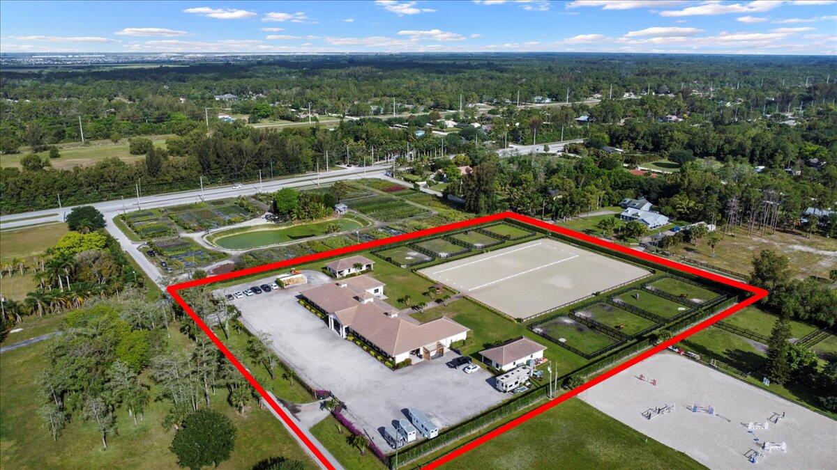 16575 Van Gogh Boulevard, Unit HORSE STALLS) Loxahatchee, FL 33470 - Photo 34 of 50 an aerial view of a pool