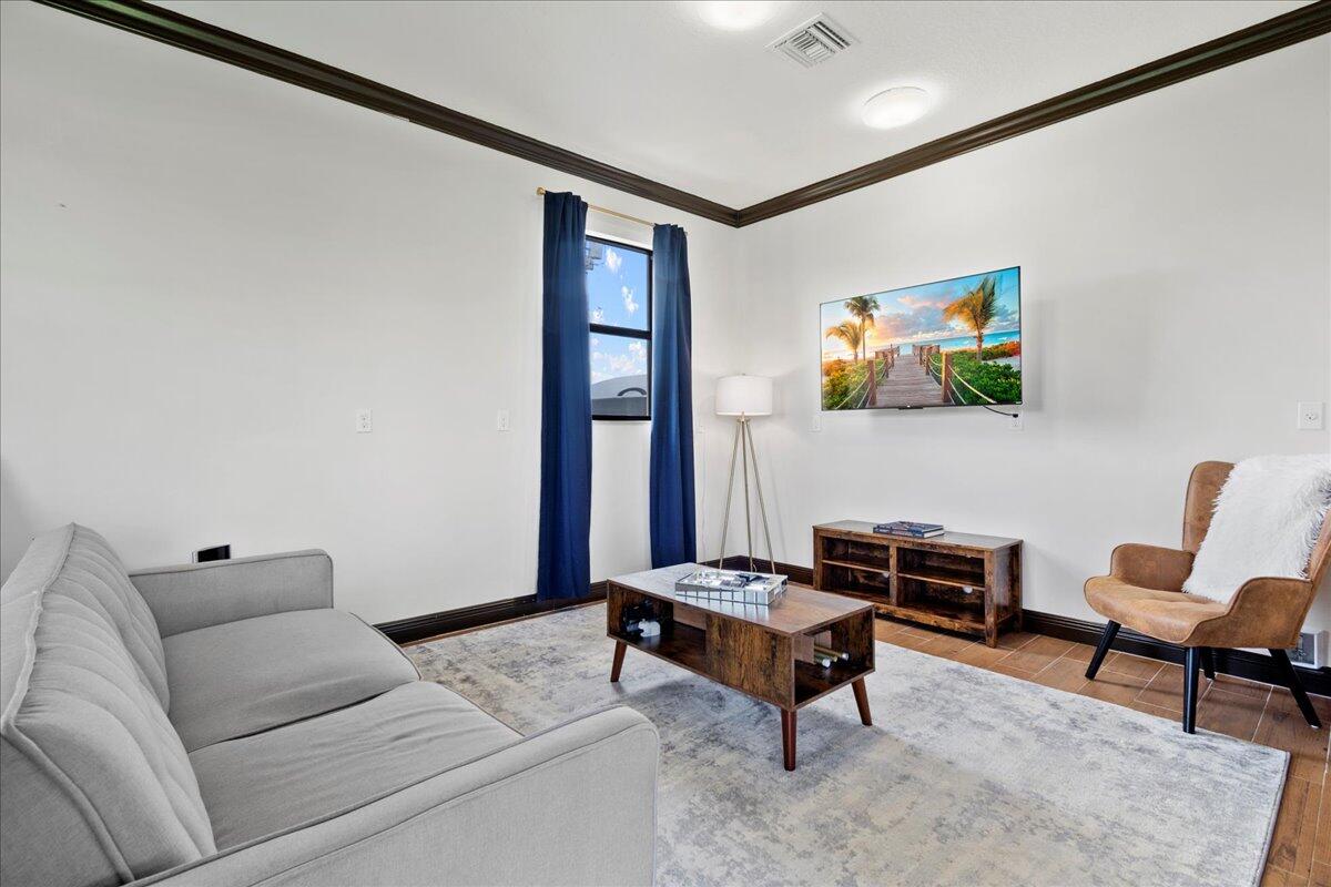 16575 Van Gogh Boulevard, Unit HORSE STALLS) Loxahatchee, FL 33470 - Photo 39 of 50 a living room with furniture and rug