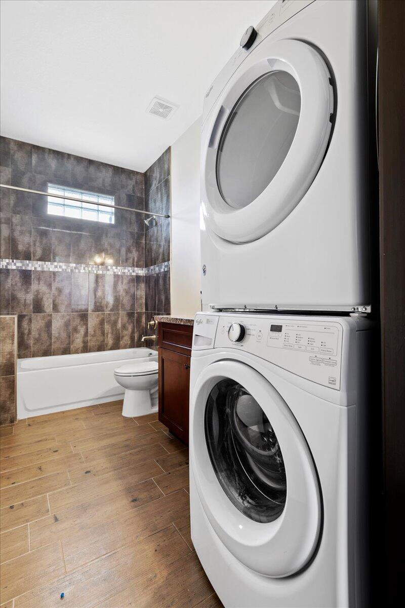 16575 Van Gogh Boulevard, Unit HORSE STALLS) Loxahatchee, FL 33470 - Photo 40 of 50 a bathroom with a toilet and a washing machine