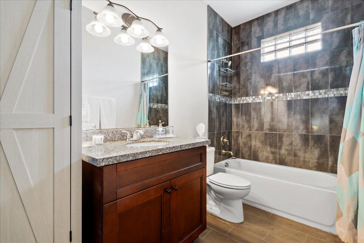 16575 Van Gogh Boulevard, Unit HORSE STALLS) Loxahatchee, FL 33470 - Photo 43 of 50 a bathroom with a granite countertop sink a toilet and bathtub