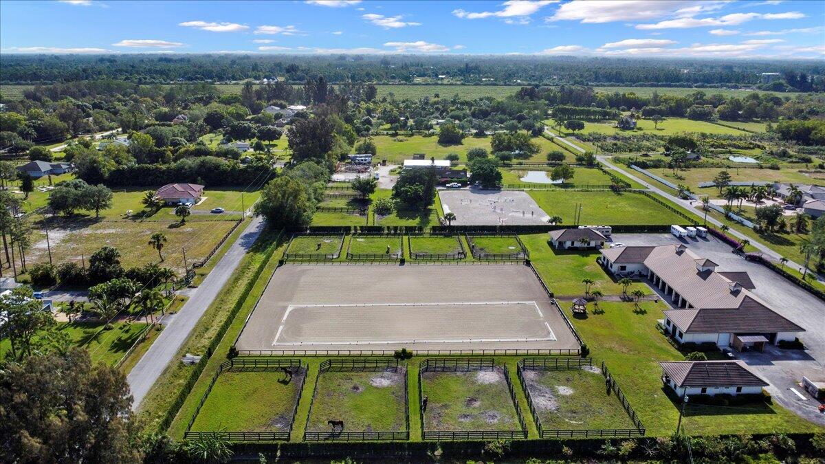 16575 Van Gogh Boulevard, Unit HORSE STALLS) Loxahatchee, FL 33470 - Photo 48 of 50 an aerial view of houses with a swimming pool