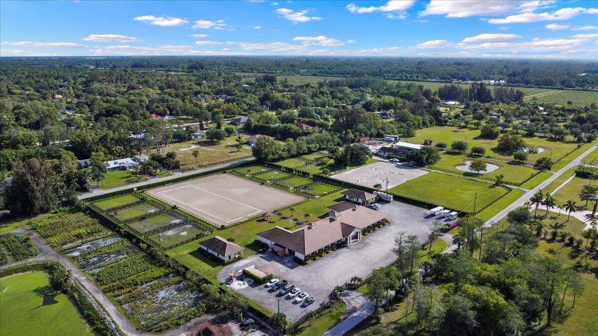 16575 Van Gogh Boulevard, Unit HORSE STALLS) Loxahatchee, FL 33470 - Photo 49 of 50 an aerial view of a residential houses with outdoor space