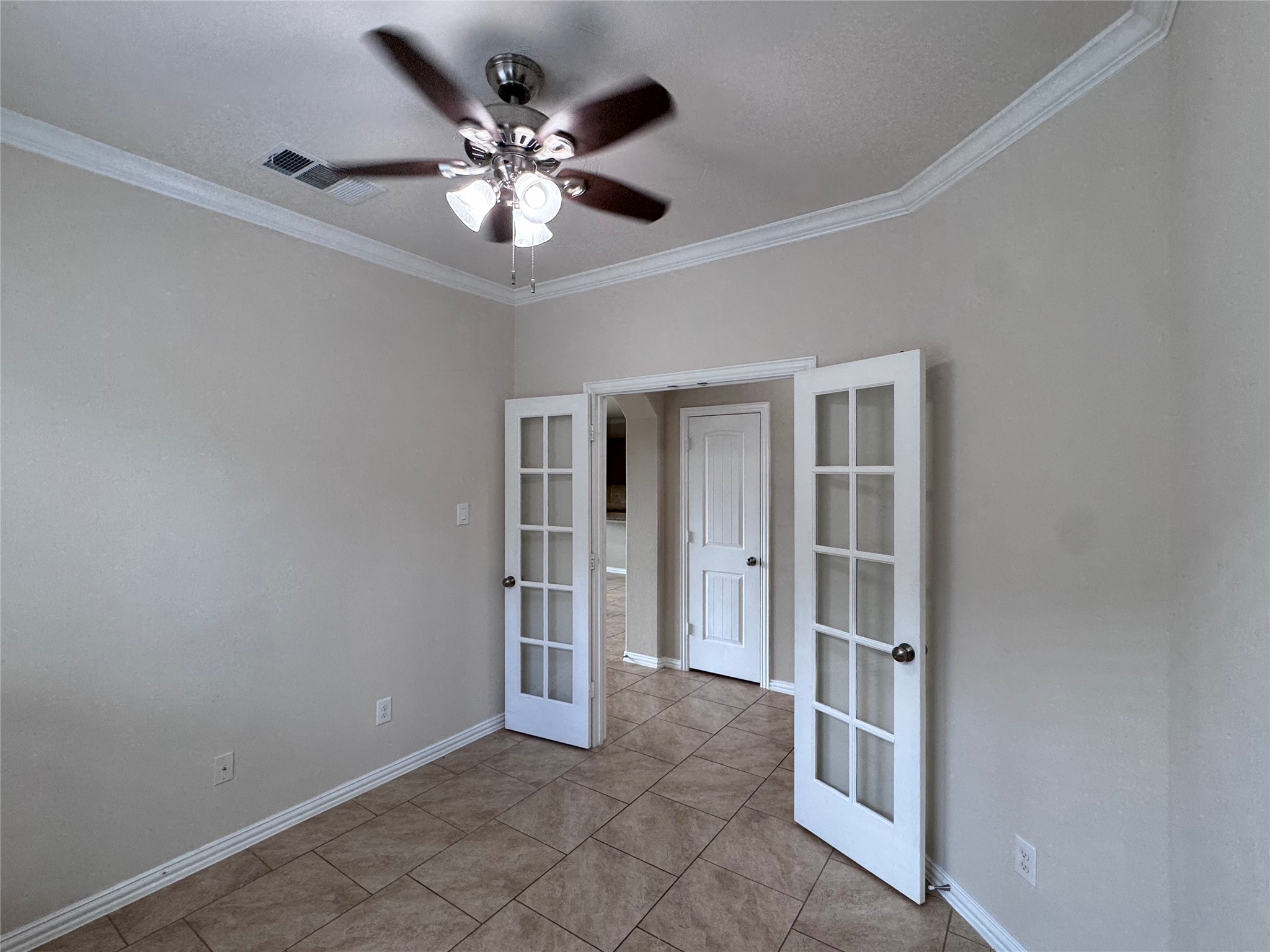 2605 Rough Berry Road Pflugerville, TX 78660 - Photo 7 of 40 French doors open to an adaptable interior space, presenting versatile options for a home office or cozy den.