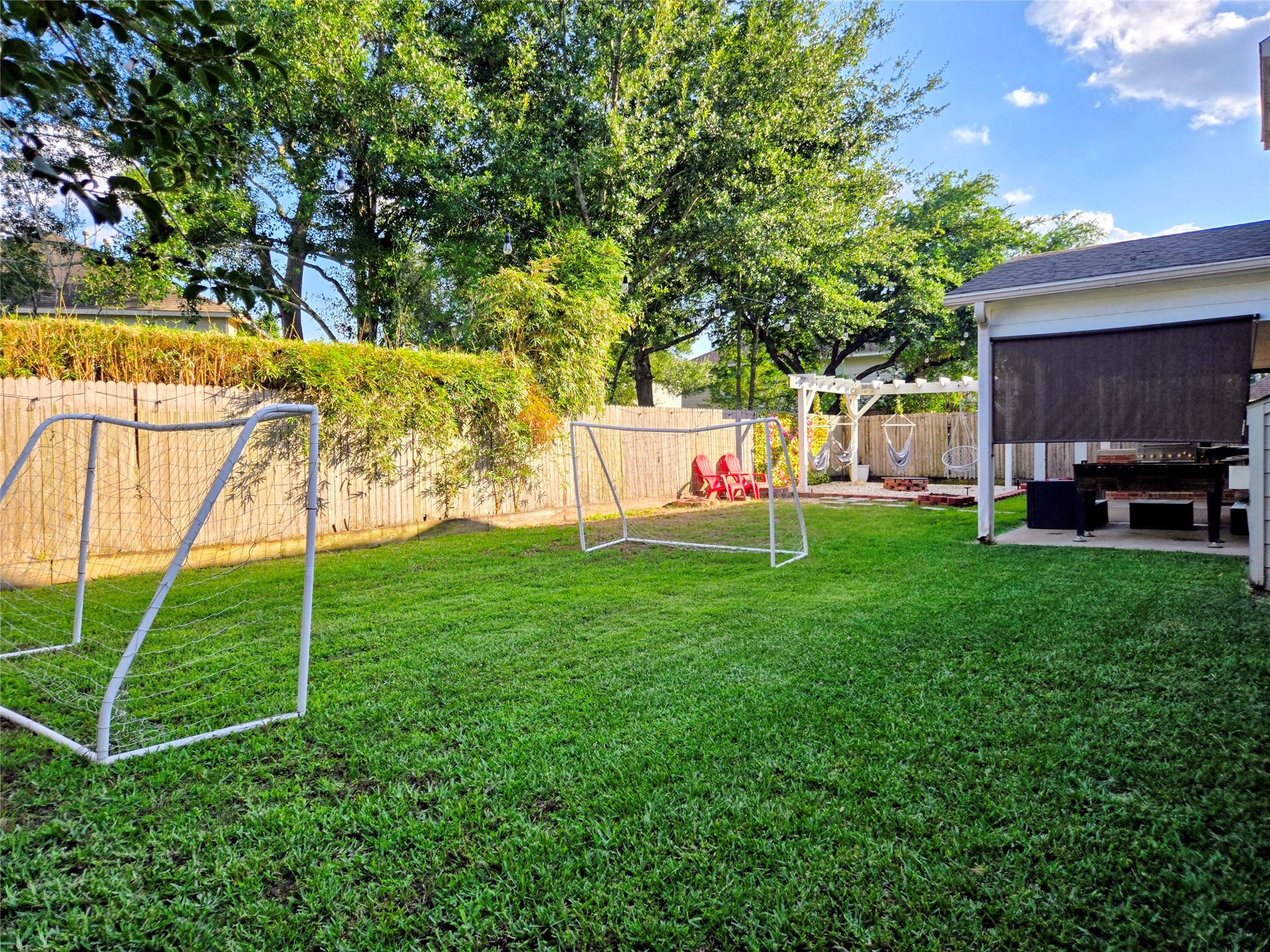 9211 Memorial Grove Drive Spring, TX 77379 - Photo 7 of 38 a view of a house with a backyard and a tree
