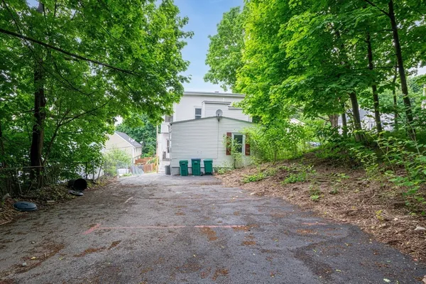 a view of a house with a tree in the background