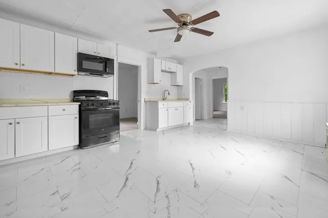 a kitchen with cabinets and window
