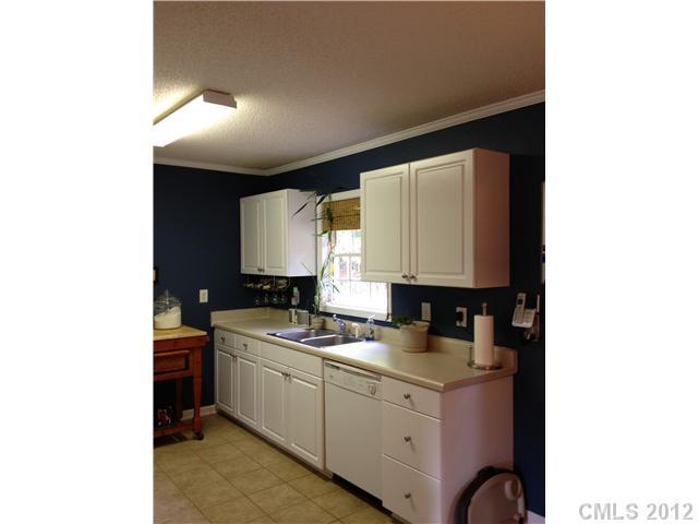 2837 Union Ridge Drive Lincolnton, NC 28092 - Photo 3 of 5 a kitchen with granite countertop white cabinets and black appliances