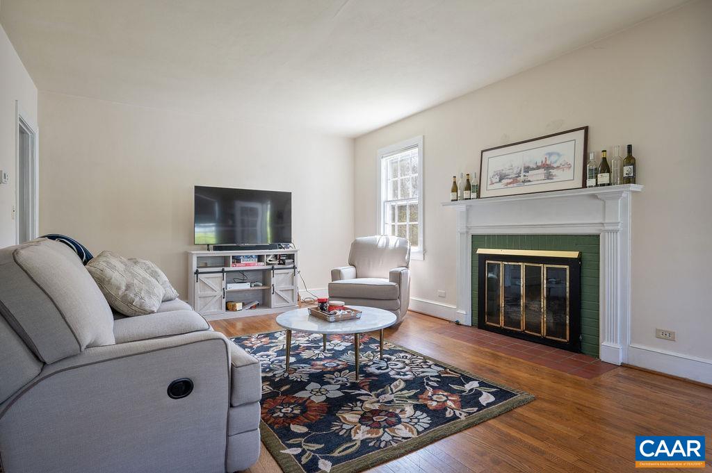 304 Alderman Road Charlottesville, VA 22903 - Photo 4 of 18 a living room with furniture a flat screen tv and a fireplace