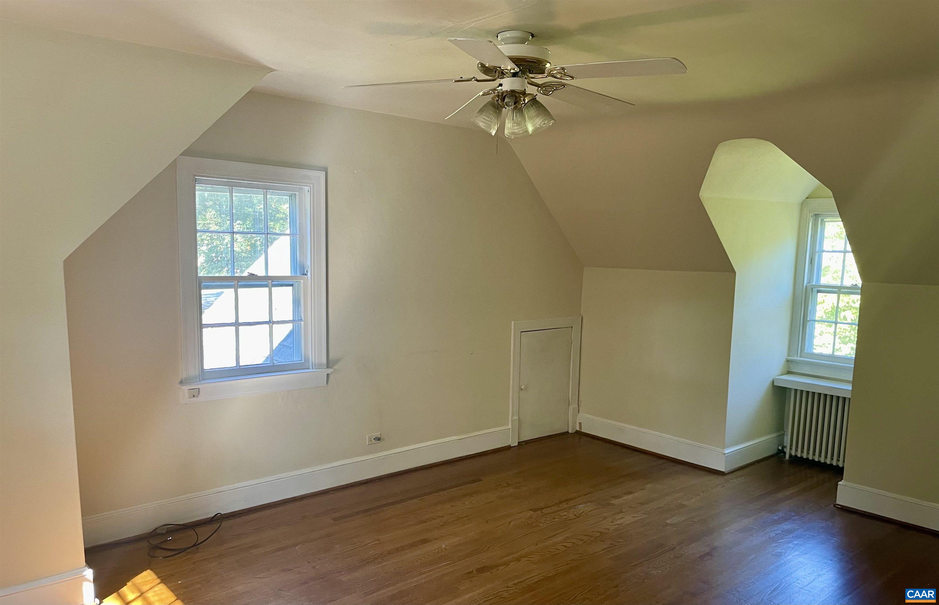 304 Alderman Road Charlottesville, VA 22903 - Photo 8 of 18 an empty room with wooden floor fan and windows