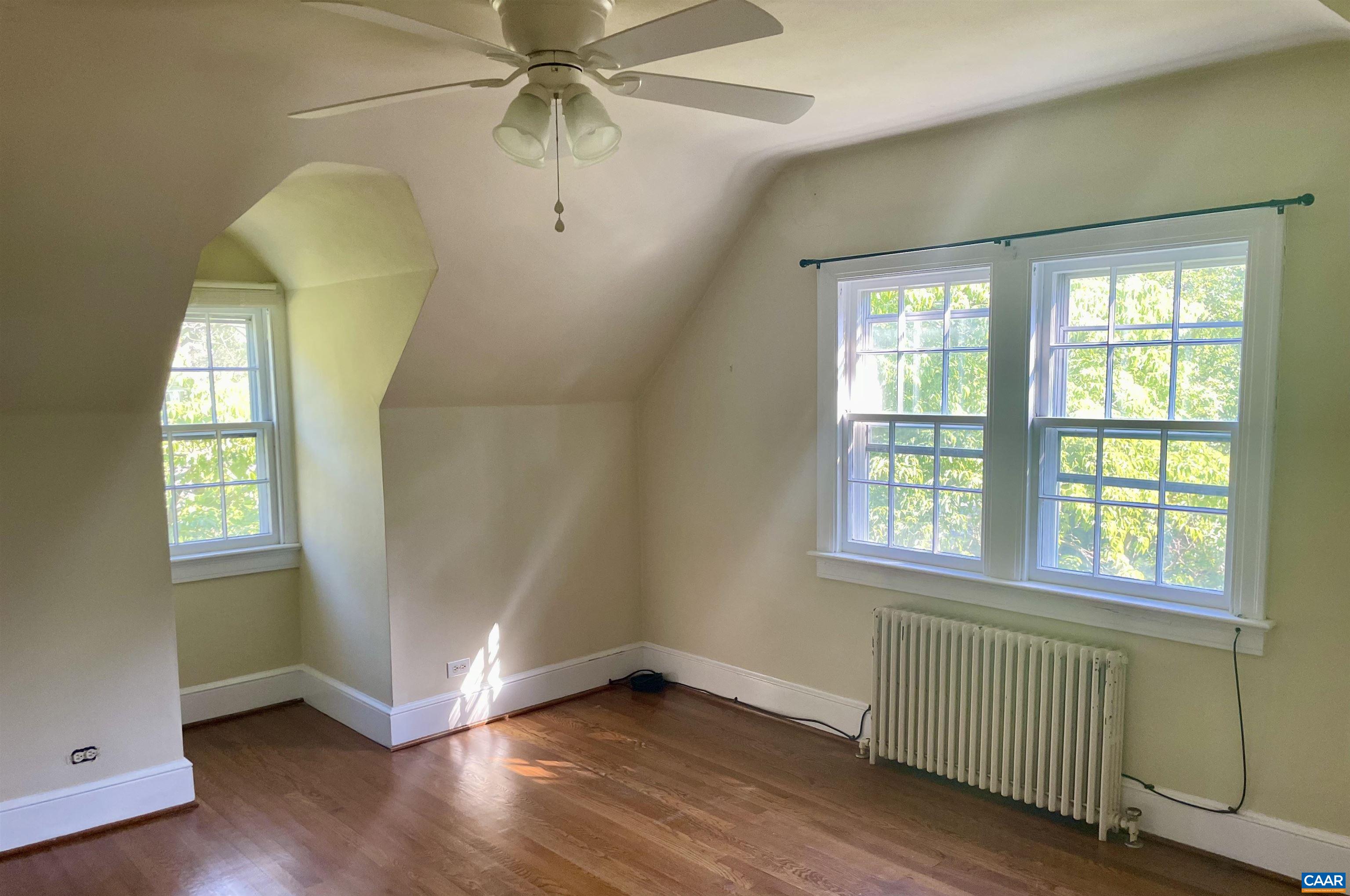304 Alderman Road Charlottesville, VA 22903 - Photo 9 of 18 an empty room with wooden floor fan and windows