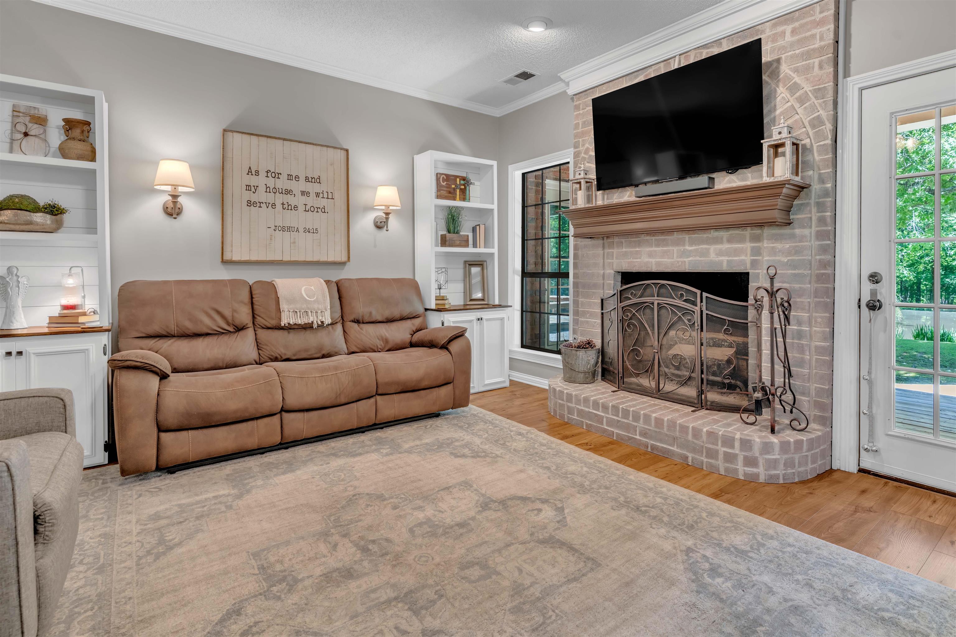 400 Great Oaks Road Eads, TN 38028 - Photo 14 of 40 a living room with furniture a flat screen tv and a fireplace