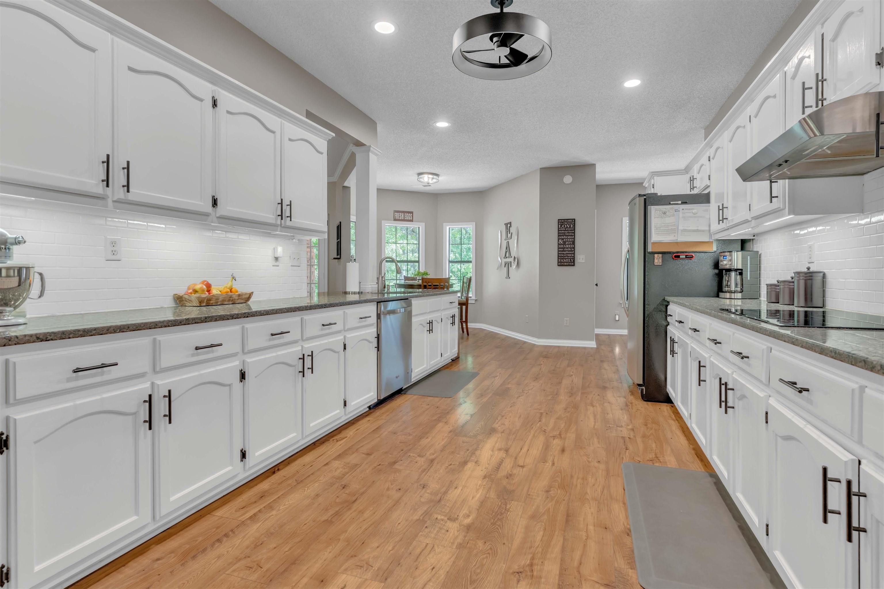 400 Great Oaks Road Eads, TN 38028 - Photo 15 of 40 a large kitchen with stainless steel appliances granite countertop a lot of counter space and wooden floors