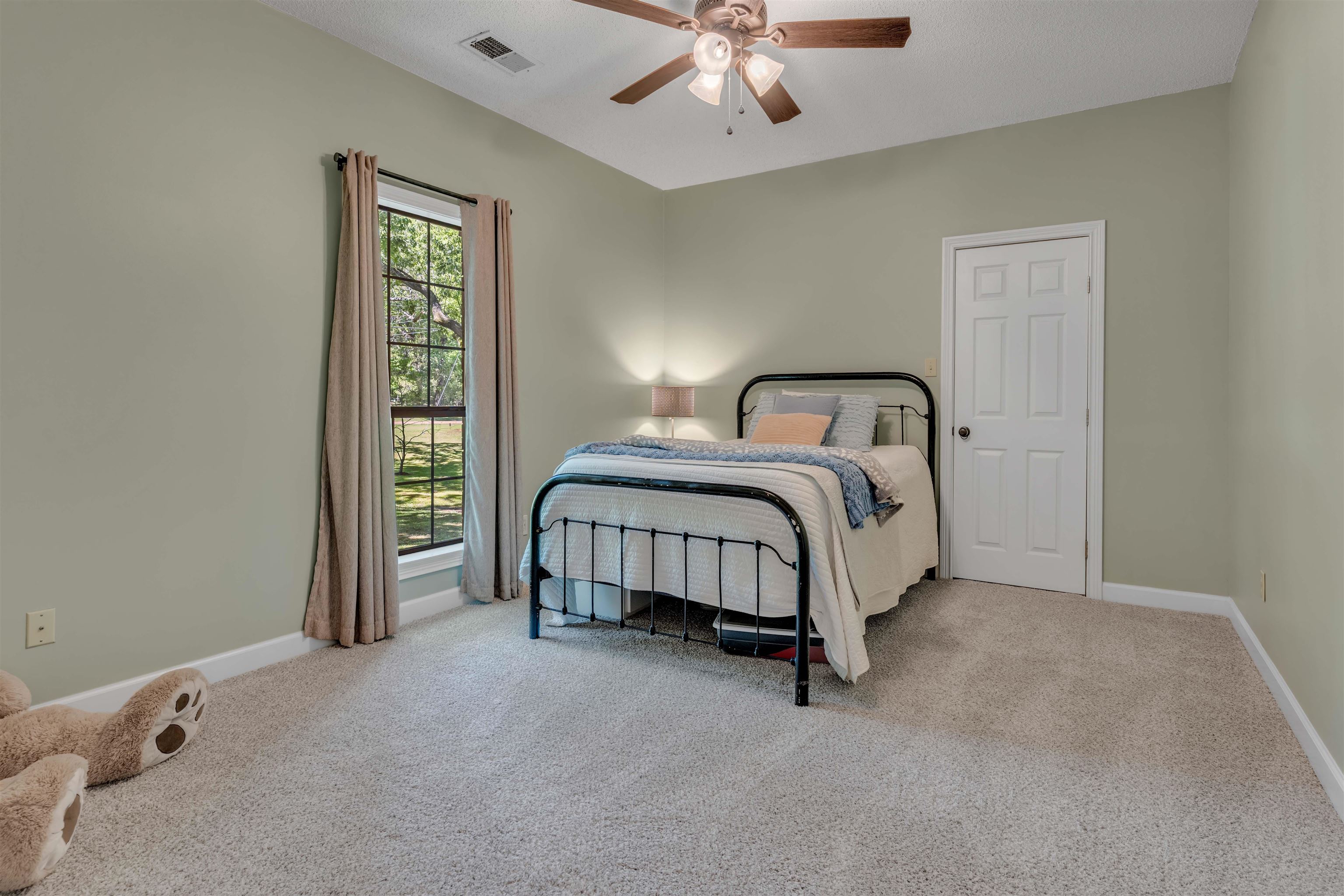 400 Great Oaks Road Eads, TN 38028 - Photo 28 of 40 a spacious bedroom with a bed and a chandelier