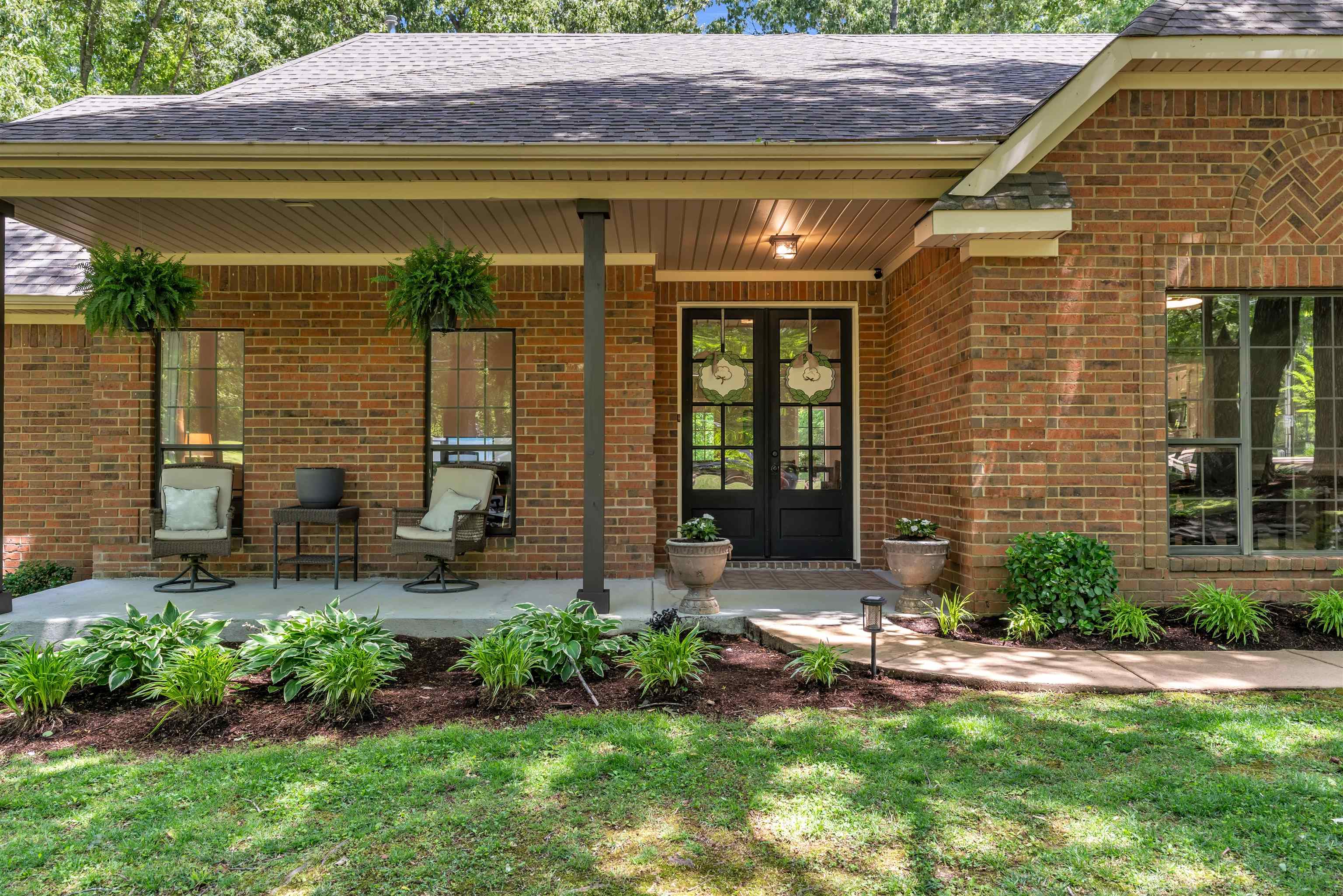 400 Great Oaks Road Eads, TN 38028 - Photo 3 of 40 a front view of a house with a yard outdoor seating and garage