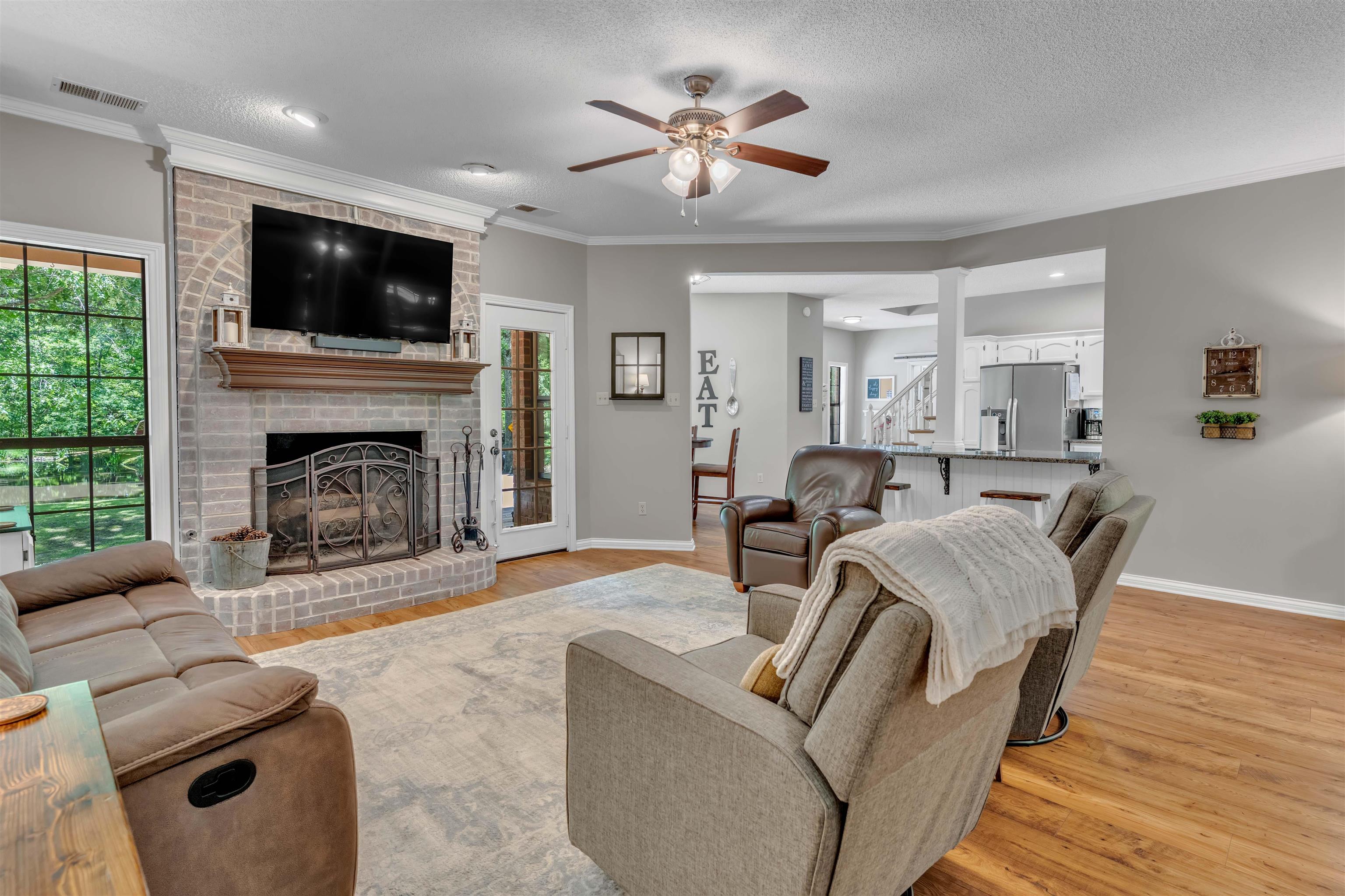 400 Great Oaks Road Eads, TN 38028 - Photo 4 of 40 a living room with furniture a flat screen tv and a fireplace