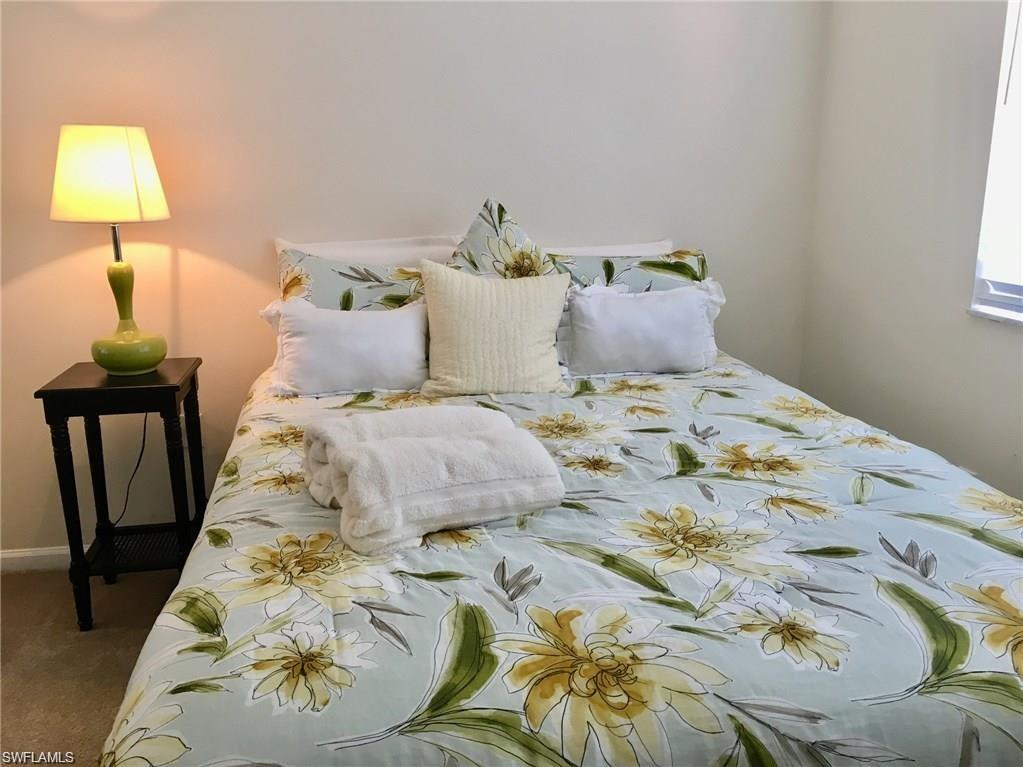 1220 Wildwood Lakes Boulevard, Unit 201 Naples, FL 34104 - Photo 15 of 35 Bedroom featuring carpet