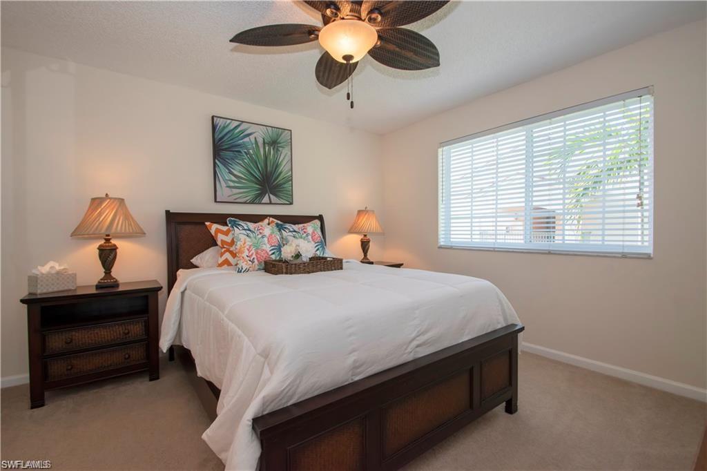 1220 Wildwood Lakes Boulevard, Unit 201 Naples, FL 34104 - Photo 20 of 35 Carpeted bedroom with ceiling fan