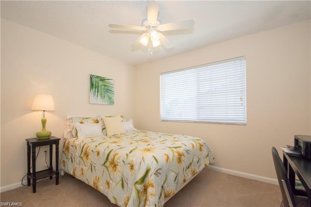 1220 Wildwood Lakes Boulevard, Unit 201 Naples, FL 34104 - Photo 23 of 35 Carpeted bedroom with ceiling fan