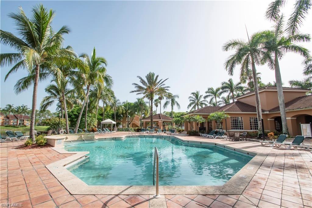 1220 Wildwood Lakes Boulevard, Unit 201 Naples, FL 34104 - Photo 25 of 35 View of swimming pool featuring a patio