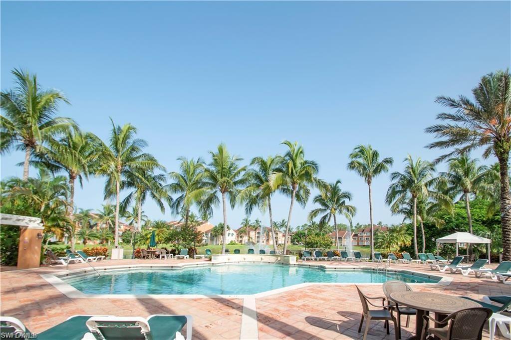 1220 Wildwood Lakes Boulevard, Unit 201 Naples, FL 34104 - Photo 26 of 35 View of swimming pool featuring a patio area