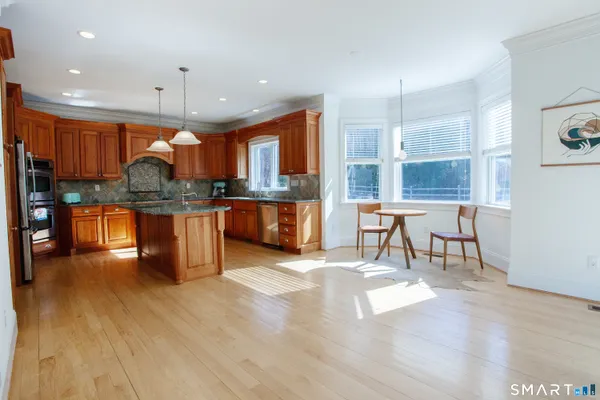 a view of a workspace room with furniture wooden floor and a window