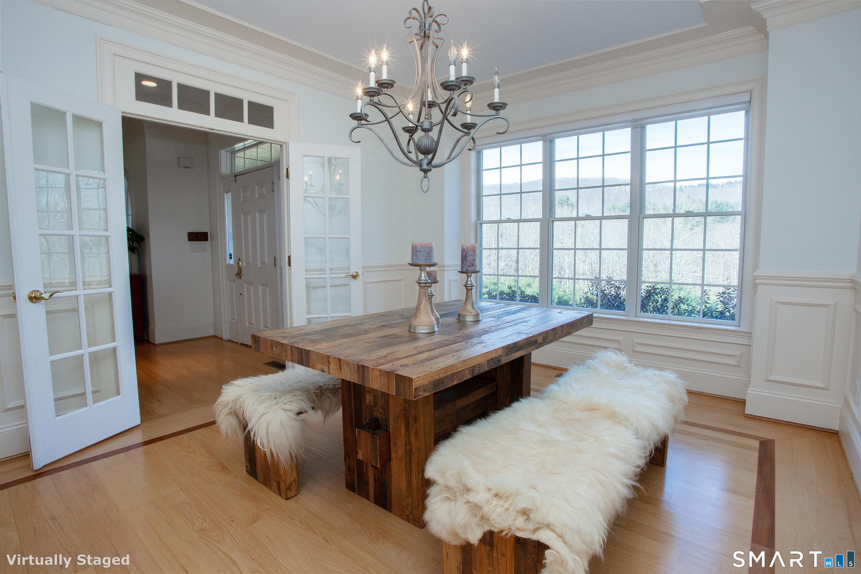 679 Cherry Brook Road Canton, CT 06019 - Photo 35 of 121 a living room with a table chairs and a chandelier
