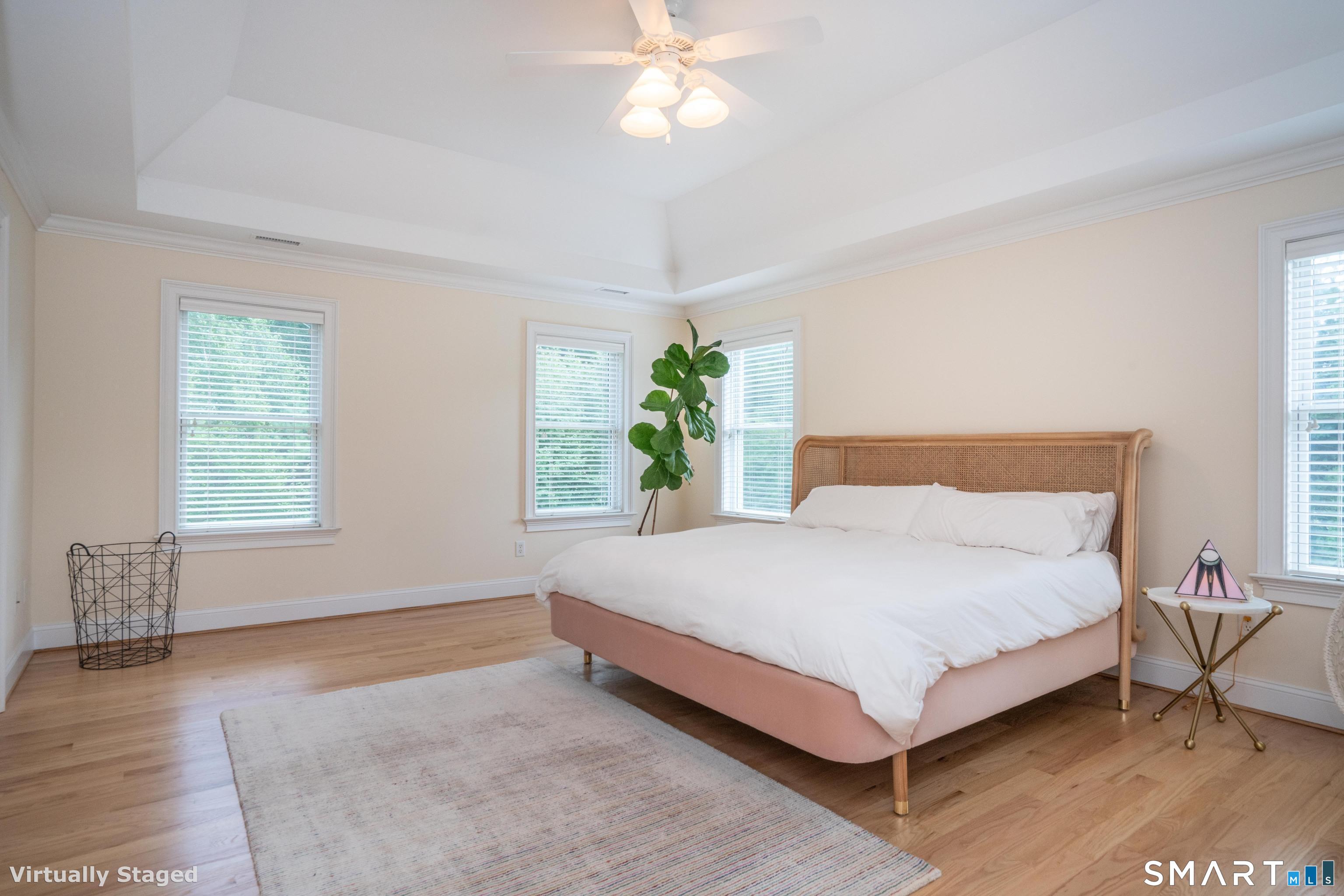 679 Cherry Brook Road Canton, CT 06019 - Photo 56 of 121 a large bed sitting in a bedroom next to a window and a chandelier