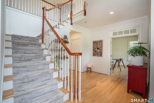 a kitchen with stainless steel appliances granite countertop a sink a stove and a refrigerator