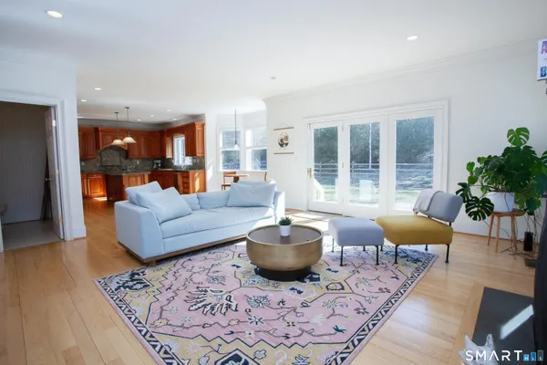 a kitchen with stainless steel appliances granite countertop a sink a stove and a wooden floors