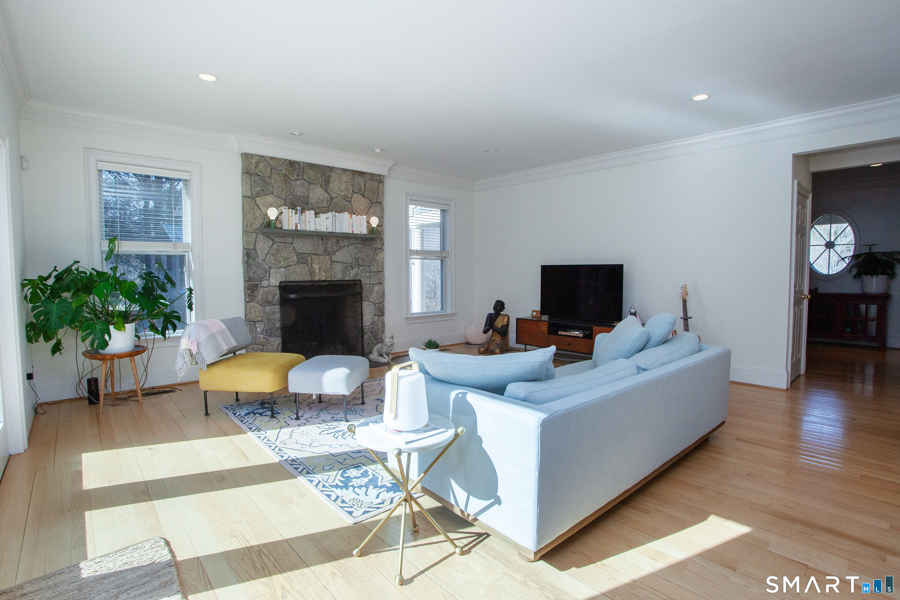 679 Cherry Brook Road Canton, CT 06019 - Photo 10 of 121 a living room with furniture a flat screen tv and a fireplace