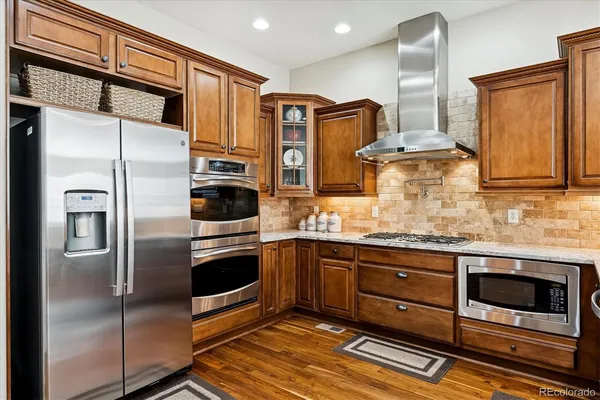 a kitchen with granite countertop wooden cabinets a sink and dishwasher