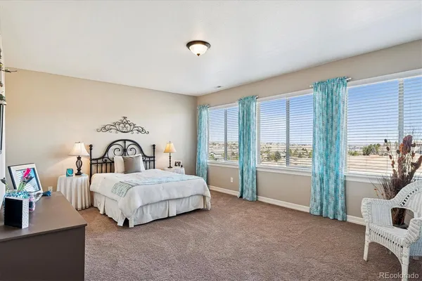 a bedroom with a bed and a car parked in it