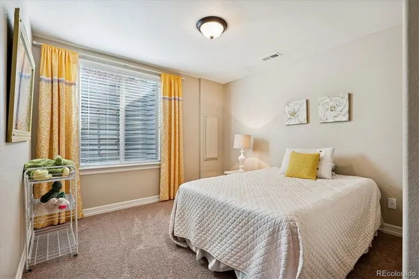 a bathroom with a granite countertop sink toilet mirror and shower