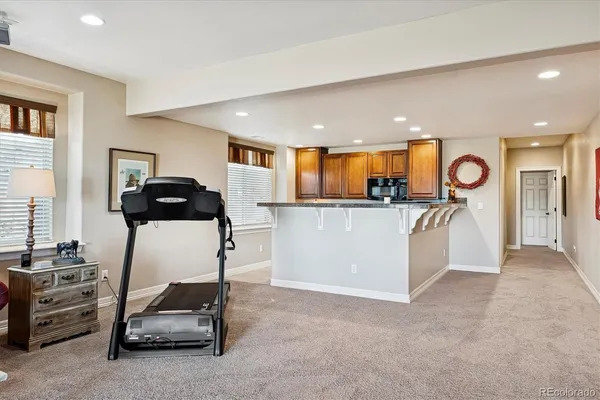 a view of kitchen with sink and refrigerator