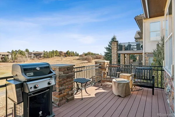 a view of a balcony with furniture and wooden floor