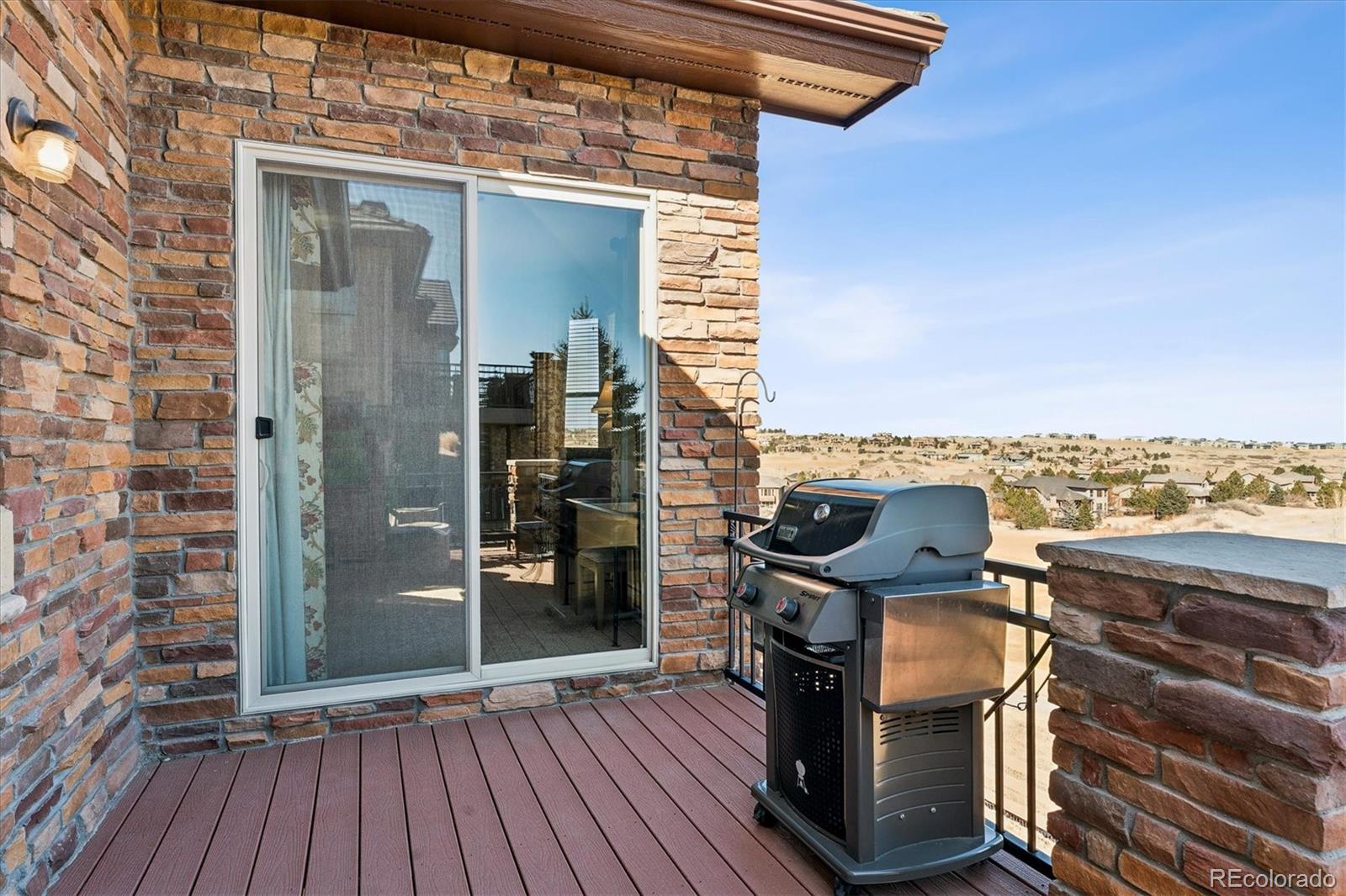 5228 Rialto Drive Parker, CO 80134 - Photo 41 of 50 a view of a balcony with furniture and wooden floor