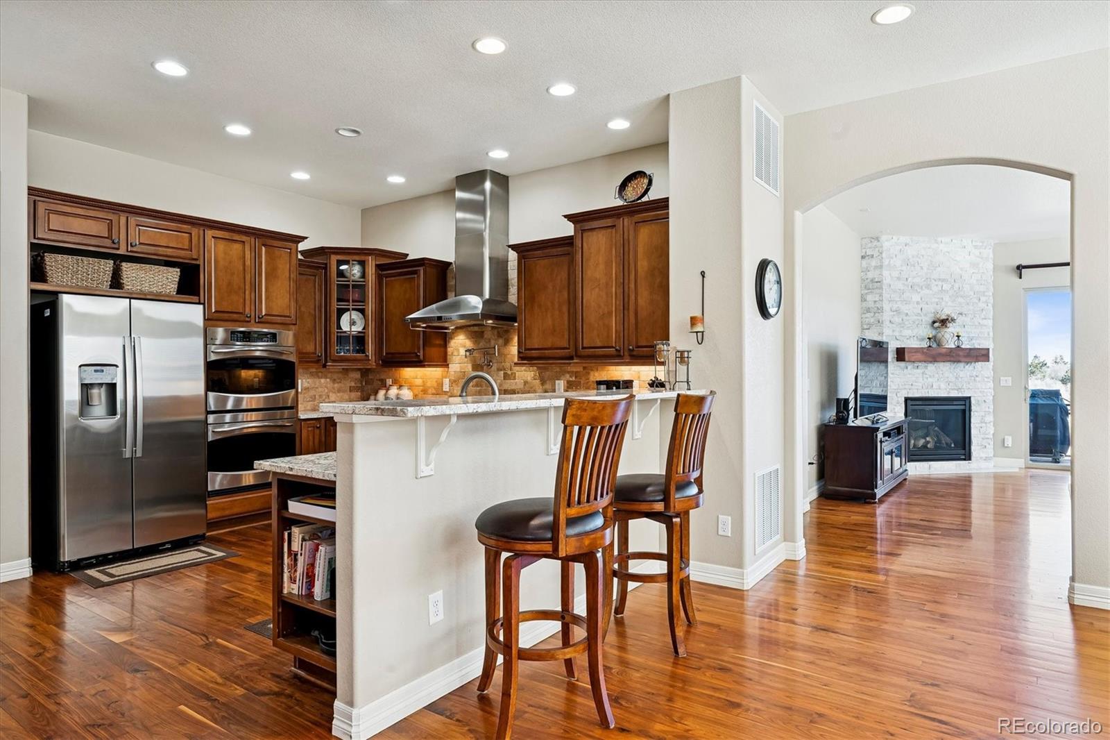 5228 Rialto Drive Parker, CO 80134 - Photo 10 of 50 a kitchen with stainless steel appliances a refrigerator a stove top oven a sink cabinets and a dining table