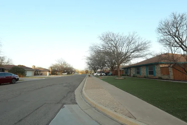 a backyard of a house with outdoor seating