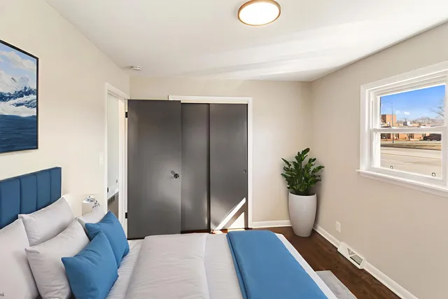 a bedroom with a bed and wooden floor