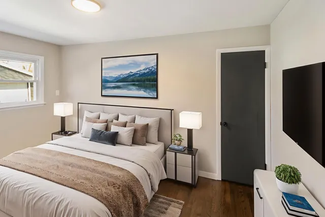 a bedroom with bed and wooden floor