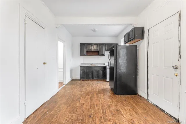 a view of a hallway with wooden floor and closet
