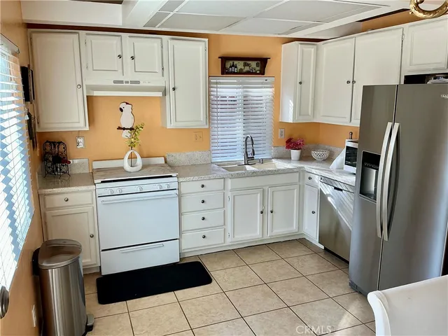 a kitchen with a stove a sink and a refrigerator