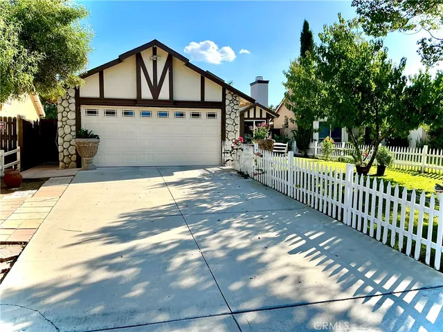 a view of a house with wooden fence