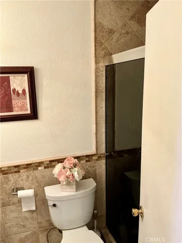 a bathroom with a sink mirror and toilet