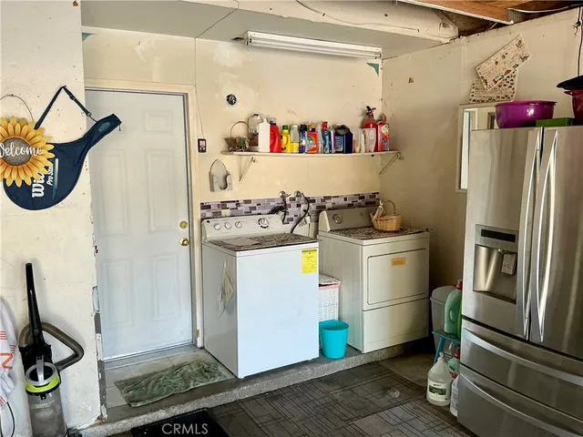 a kitchen with refrigerator and cabinets