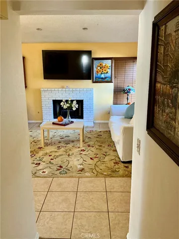 a living room with a fireplace and a flat screen tv
