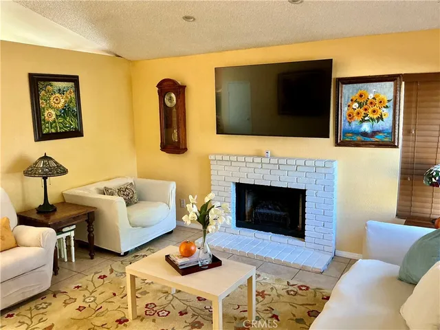 a living room with furniture fireplace and flat screen tv