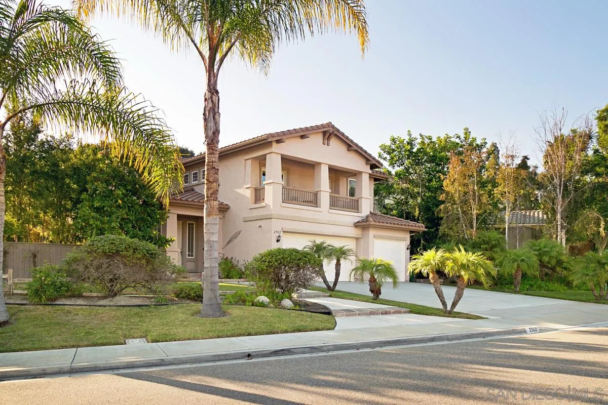 2902 Rancho Rio Chico Carlsbad, CA 92009 - Photo 2 of 30 a white house with a palm tree in the background